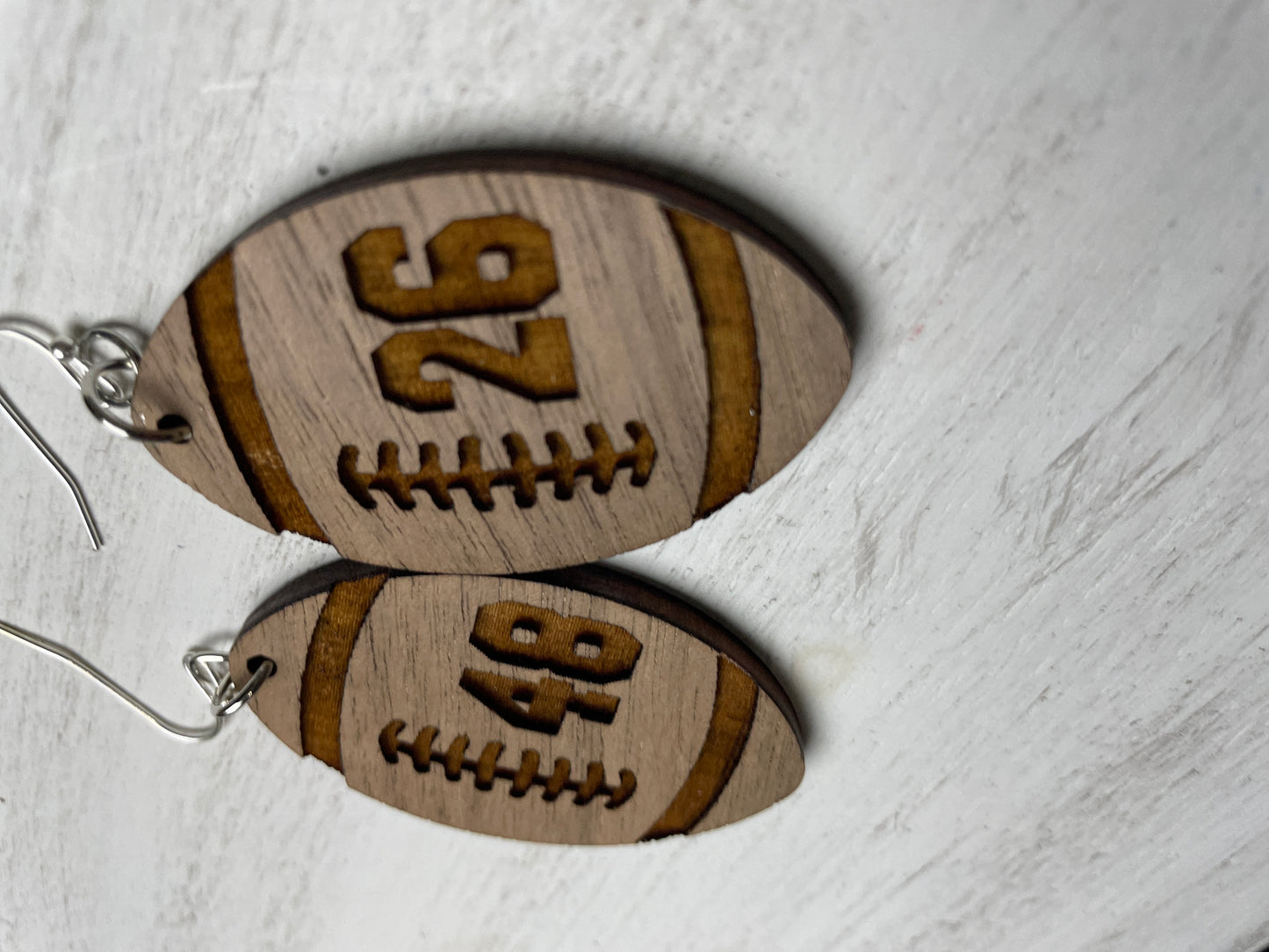 football shape earring with engraved number