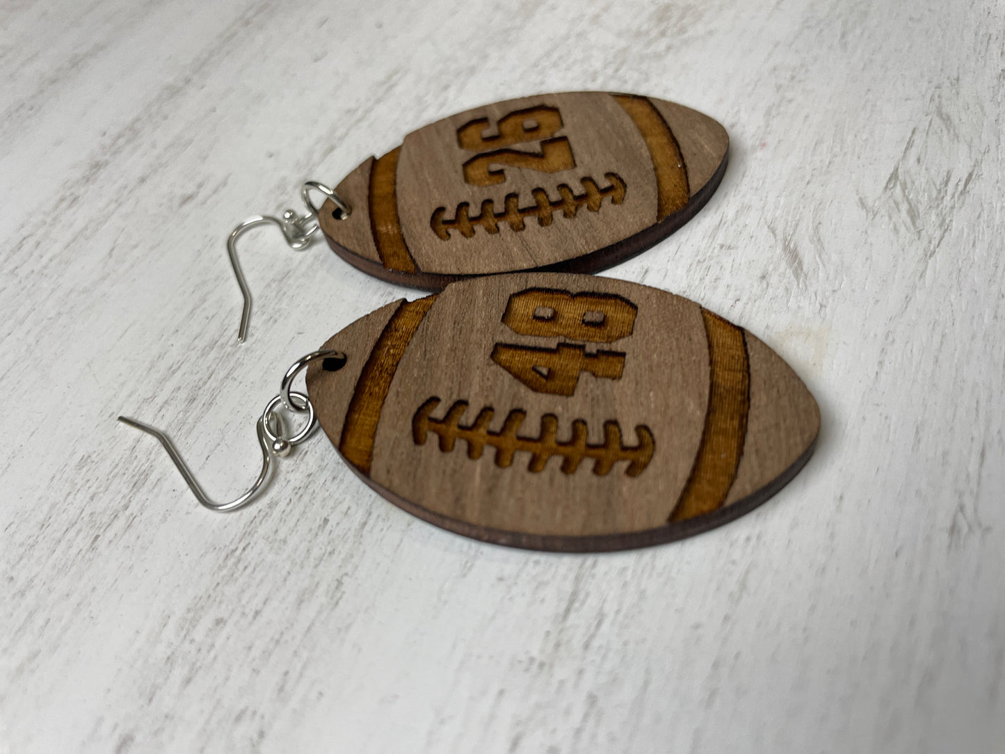 football shape earring with engraved number