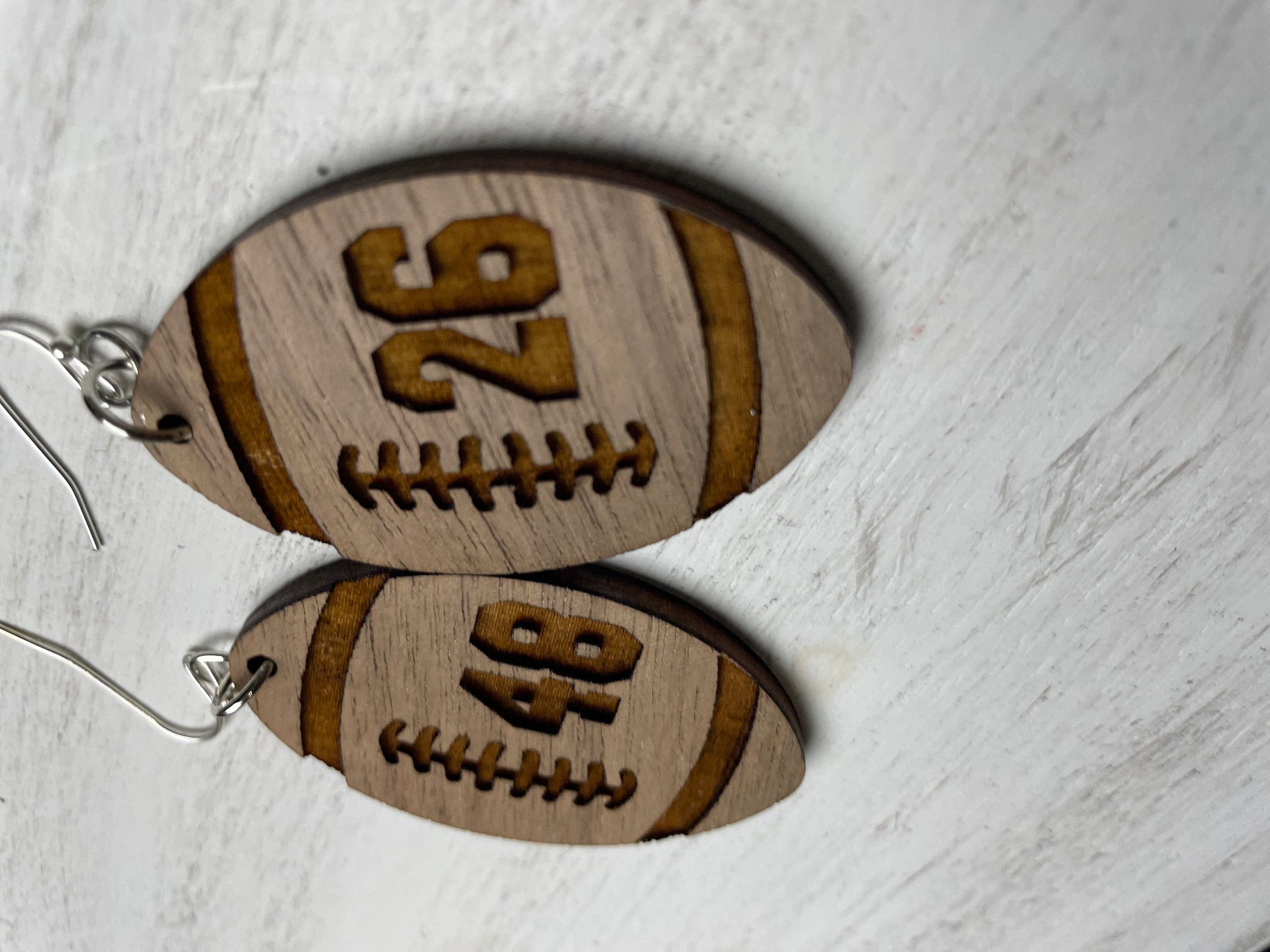 football shape earring with engraved number